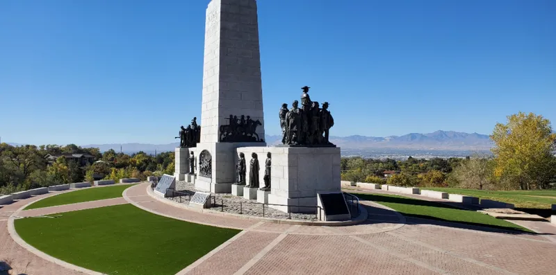 Commercial artificial turf beds bordering the brick plaza of a Salt Lake City monument